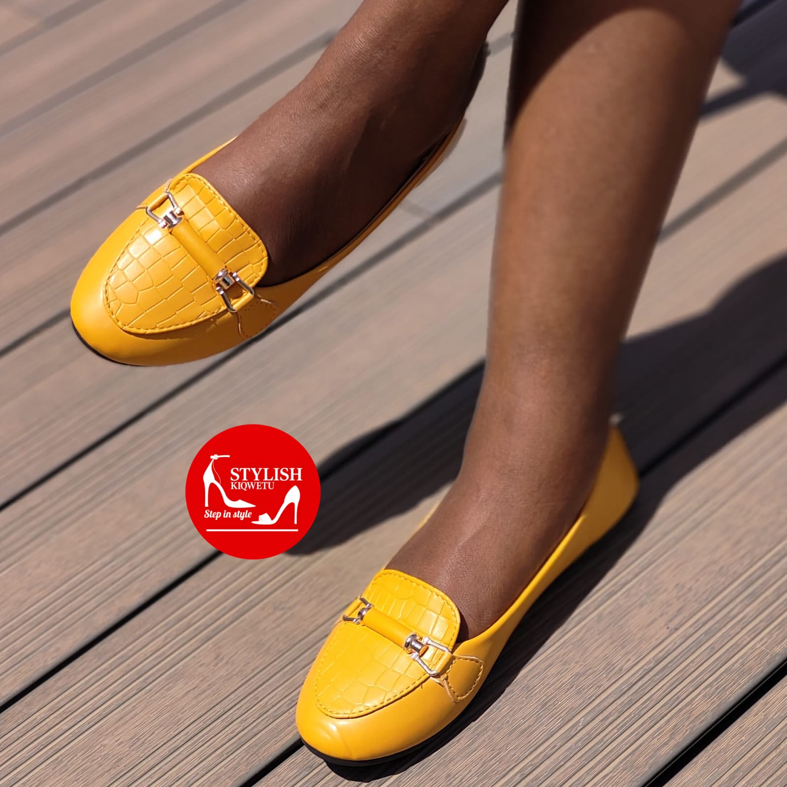 yellow crocodile-embossed flat shoes.
